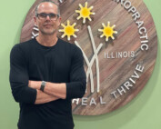 Dr. McKinley standing in front of his business sign